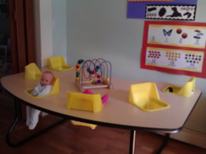 Infant in highchair at First Tiny Steps a daycare in Astoria